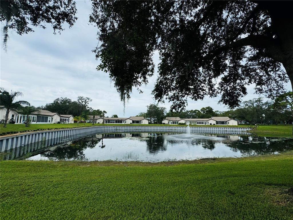 7559 Heather Walk Drive Weeki Wachee, FL 34613 - Photo 22 of 26 a view of lake with green space and bench