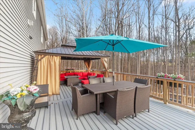 a spacious bedroom with a bed a couch and a window