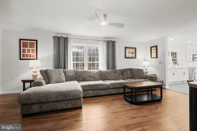 a spacious bedroom with a bed and wooden floor