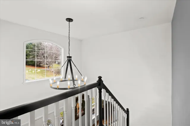 a bedroom with bed and a large window