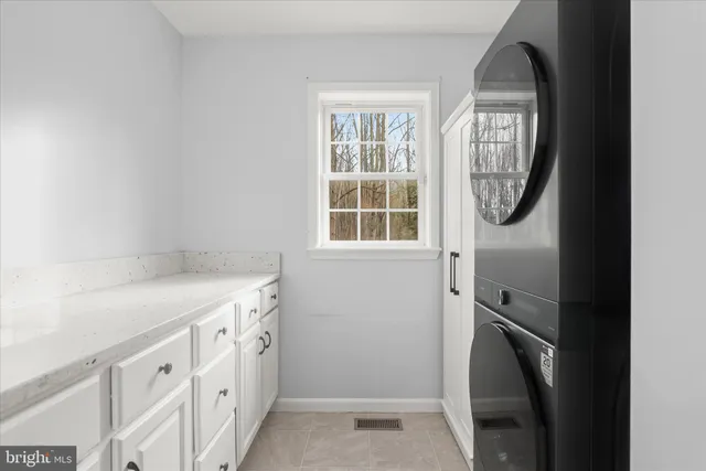 a open kitchen with stainless steel appliances granite countertop a refrigerator a stove a sink dishwasher a dining table and chairs with wooden floor