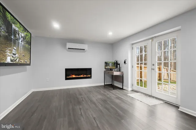 a view of a room with wooden floor and windows