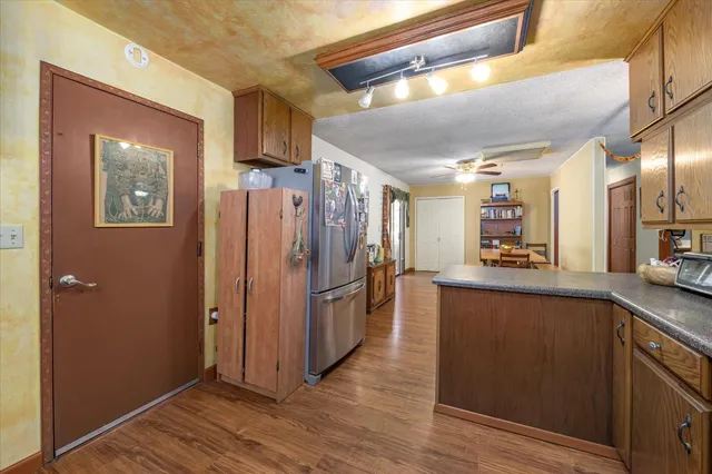a kitchen with stainless steel appliances granite countertop a refrigerator and a sink