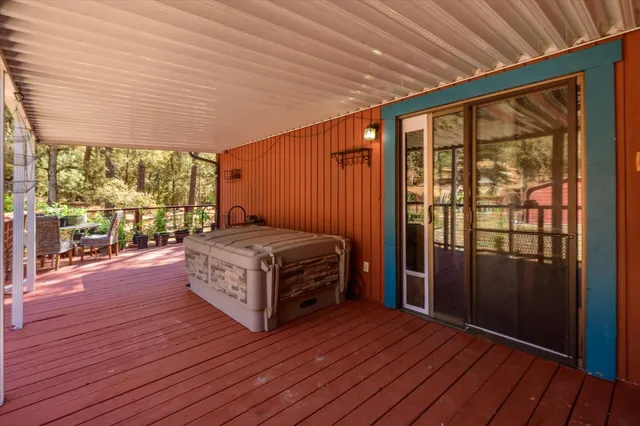 a spacious bedroom with a bed and wooden floor