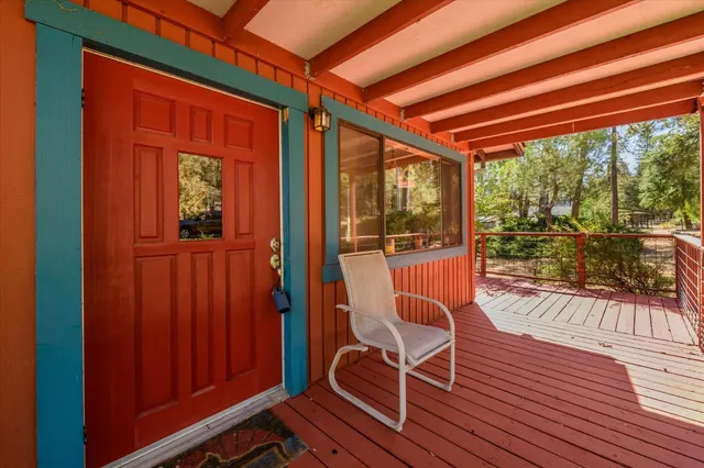 a view of a balcony with wooden floor and outdoor seating
