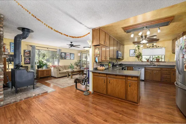 a kitchen with lots of counter top space and wooden floor