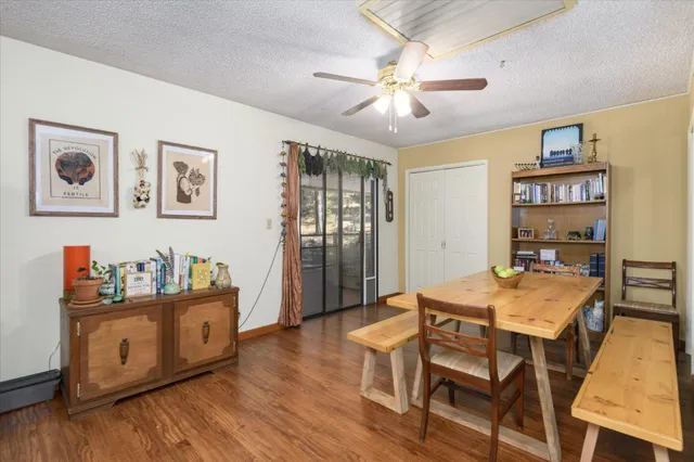 a view of a dining room with furniture and wooden floor