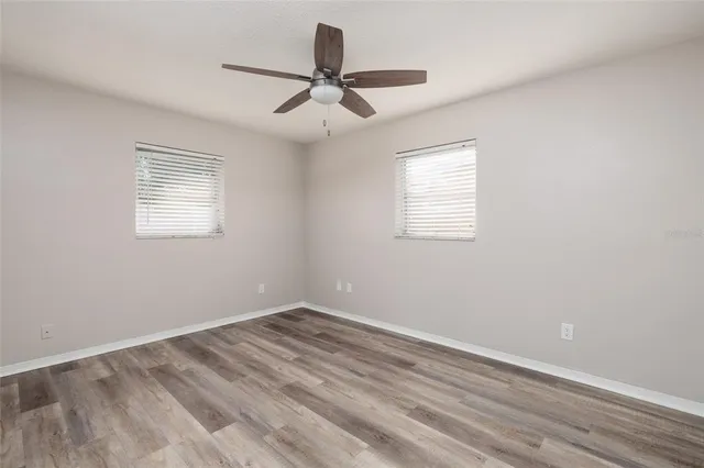 wooden floor in an empty room with a window
