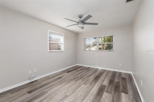 wooden floor in an empty room with a window