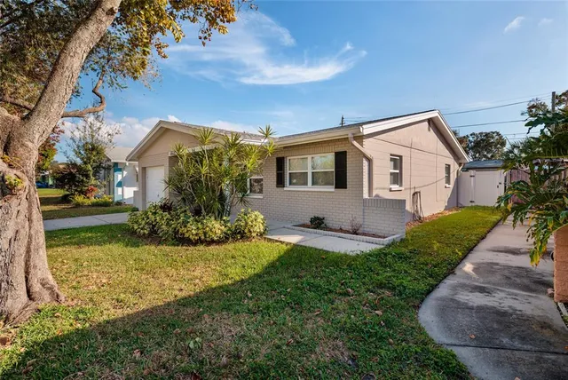 a front view of house with yard and green space
