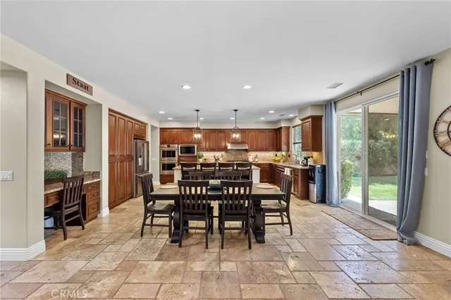 a kitchen with stainless steel appliances granite countertop a sink and stove