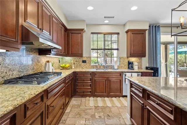 a large kitchen with kitchen island a large counter space appliances and a center island