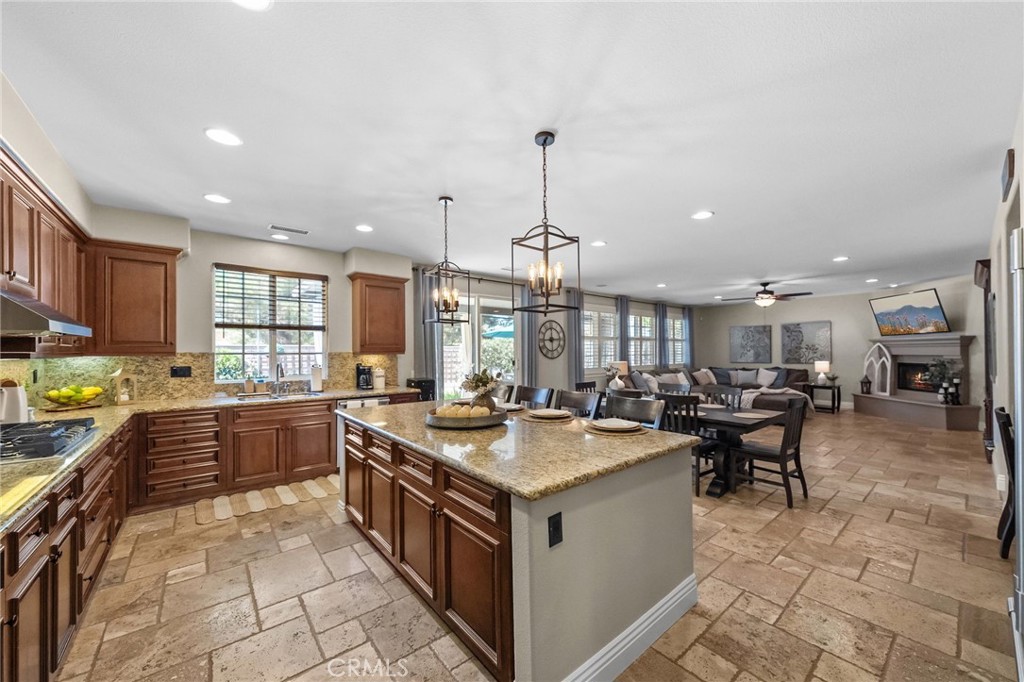 46331 Hunter Trail Temecula, CA 92592 - Photo 23 of 62 a large kitchen with kitchen island a large counter space appliances and a center island