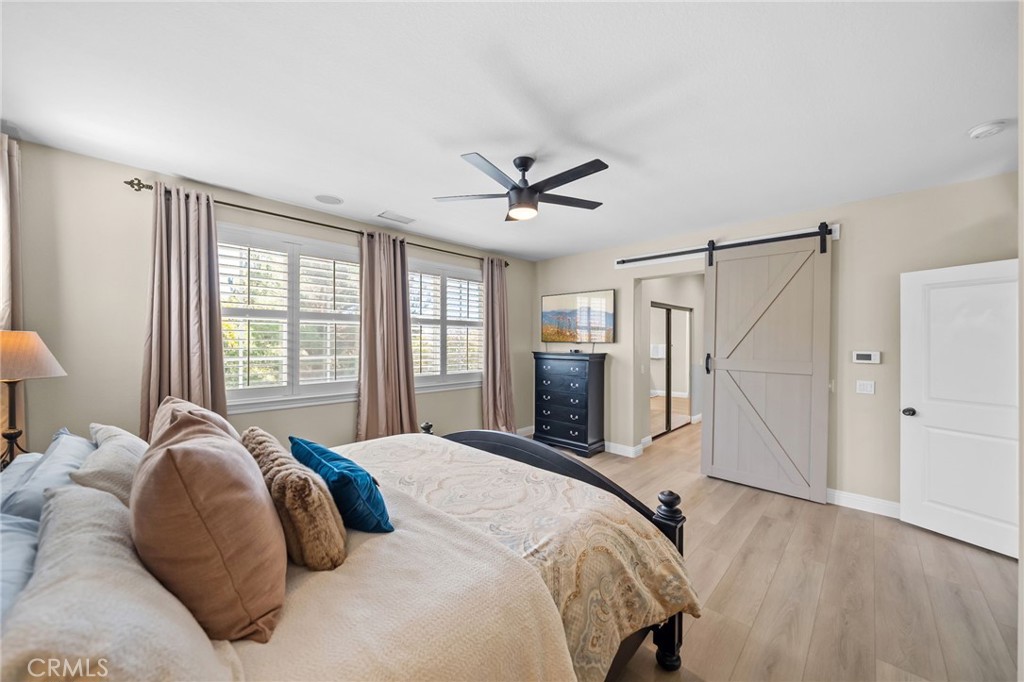 46331 Hunter Trail Temecula, CA 92592 - Photo 36 of 62 a bed room with a bed and a ceiling fan