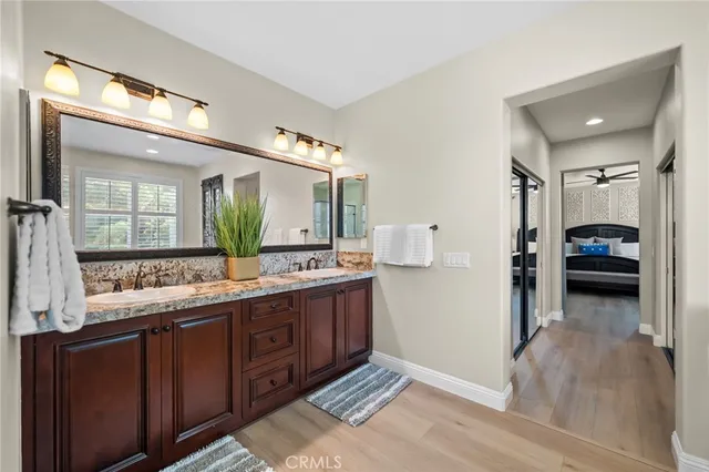 a view of a patio with table and chairs potted plants and large tree