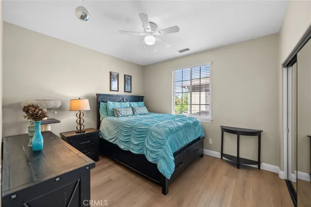a view of a patio with couches and chairs under an umbrella