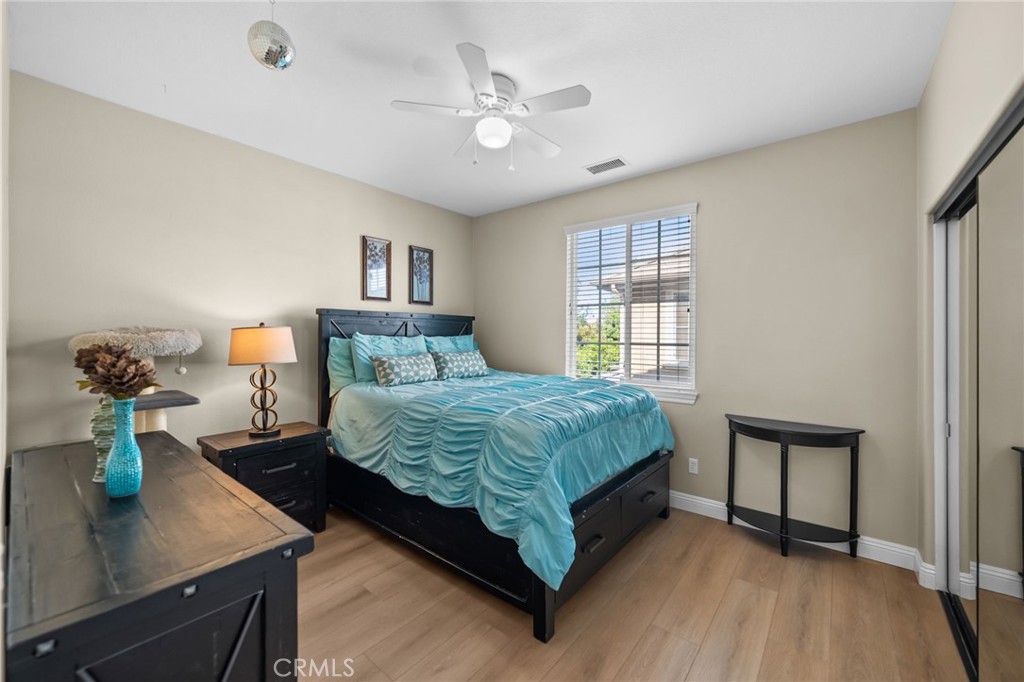 46331 Hunter Trail Temecula, CA 92592 - Photo 45 of 62 a bedroom with a bed and a chandelier