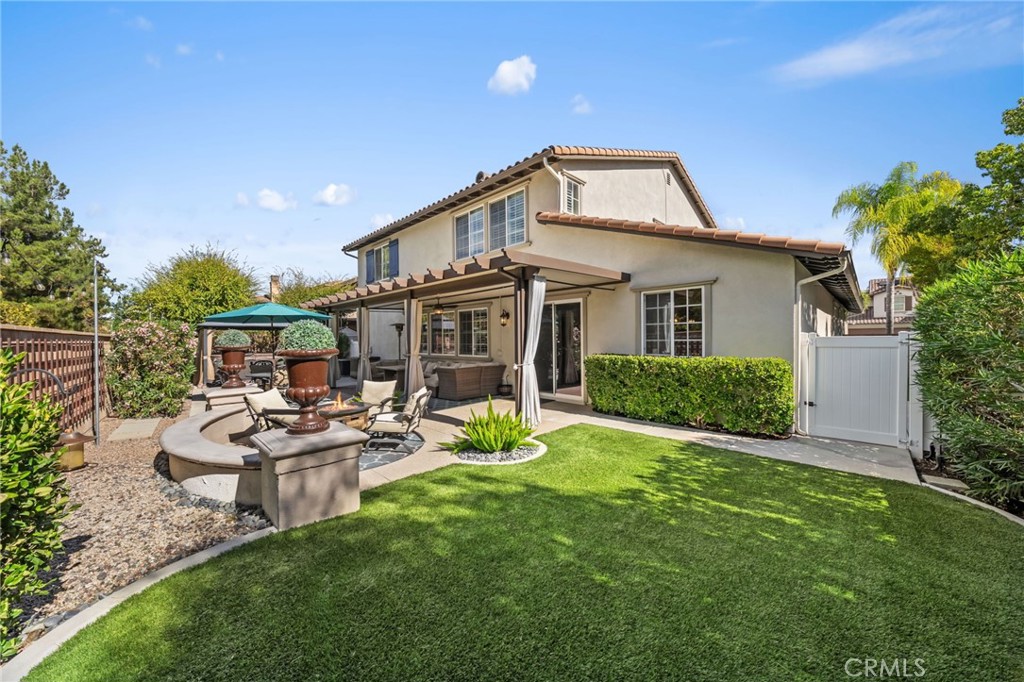46331 Hunter Trail Temecula, CA 92592 - Photo 49 of 62 a view of a house with backyard sitting area and garden