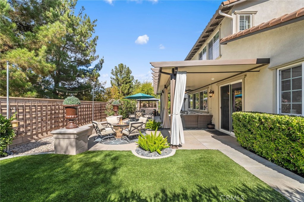 46331 Hunter Trail Temecula, CA 92592 - Photo 50 of 62 a view of a patio with table and chairs potted plants and large tree