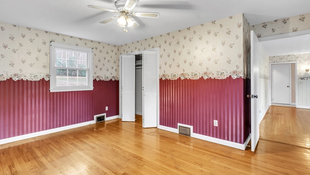 2022 Calkins Road Palmer, MA 01069 - Photo 18 of 38 a view of a bedroom with wooden floor and windows