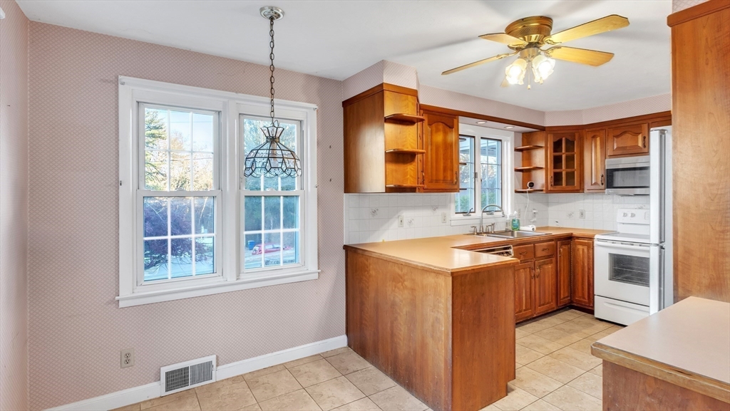 2022 Calkins Road Palmer, MA 01069 - Photo 8 of 38 a kitchen with a stove a sink and a chandelier