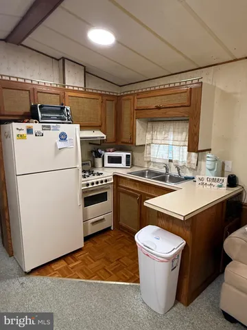 a kitchen with a sink a stove a refrigerator and a stove