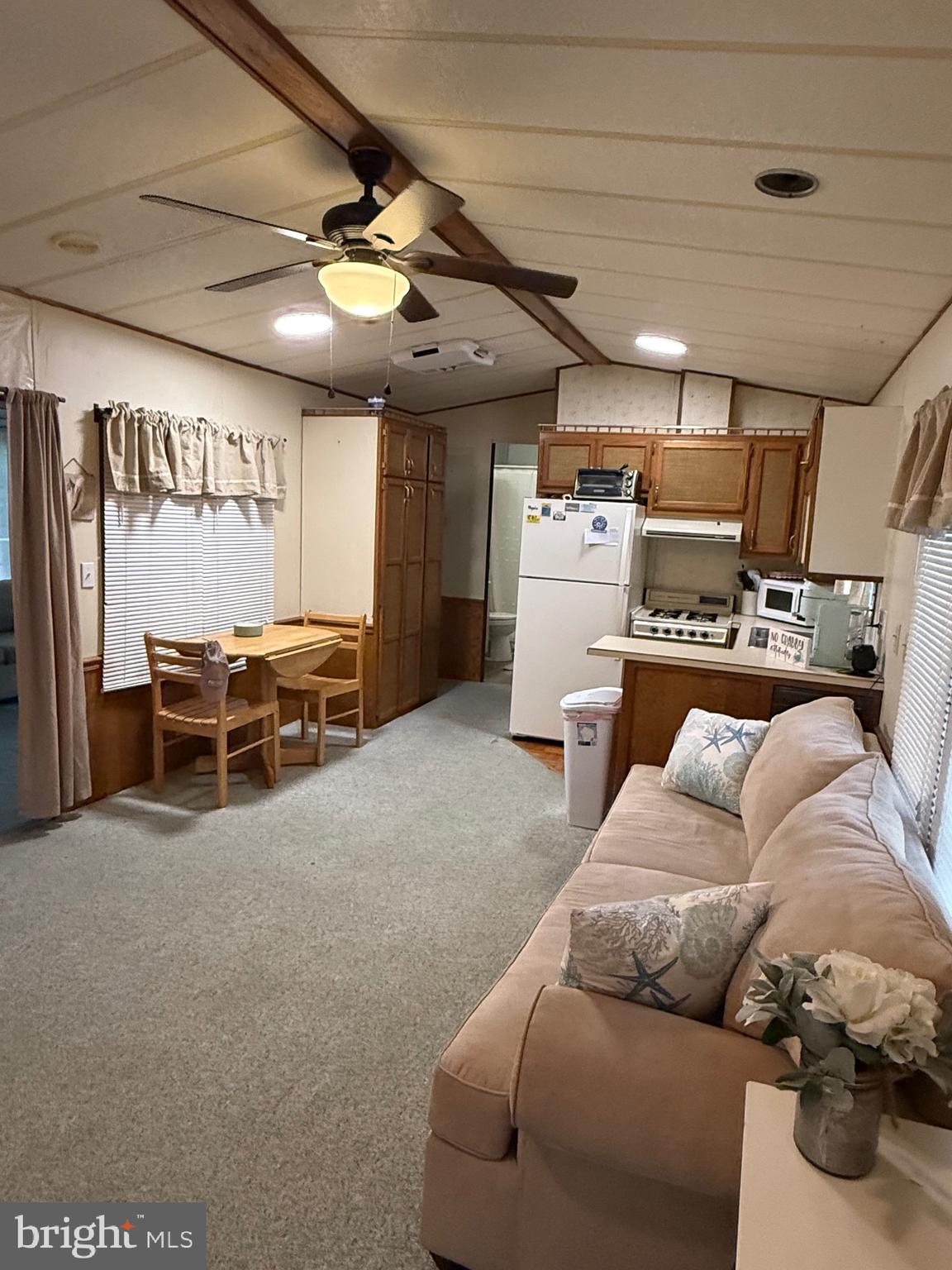 3066 Highway 9, Unit 246 Ocean View, NJ 08230 - Photo 5 of 8 a living room with furniture and a ceiling fan