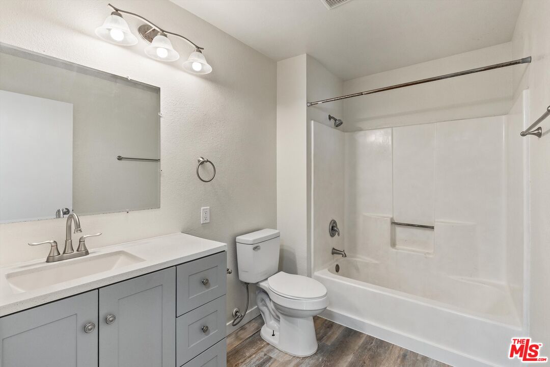 331 East Washington Avenue, Unit F Escondido, CA 92025 - Photo 14 of 19 a bathroom with a toilet a sink a mirror a bathtub and vanity
