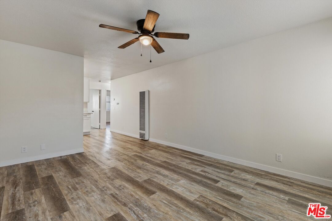 331 East Washington Avenue, Unit F Escondido, CA 92025 - Photo 3 of 19 a view of a livingroom with wooden floor and a ceiling fan