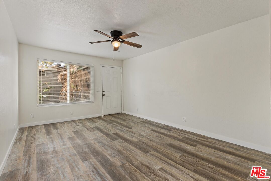 331 East Washington Avenue, Unit F Escondido, CA 92025 - Photo 4 of 19 a view of empty room with wooden floor and fan