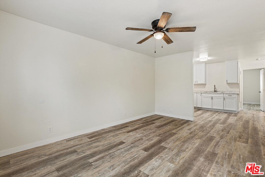 331 East Washington Avenue, Unit F Escondido, CA 92025 - Photo 5 of 19 a view of empty room with wooden floor and ceiling fan