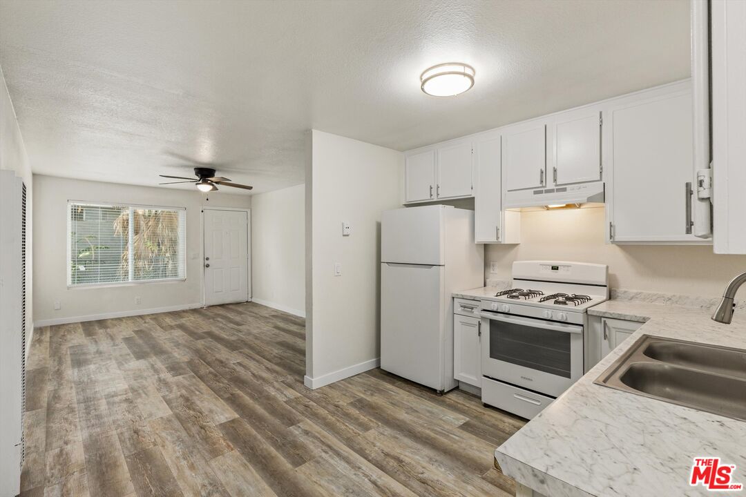 331 East Washington Avenue, Unit F Escondido, CA 92025 - Photo 8 of 19 a kitchen with a stove a refrigerator and a cabinets