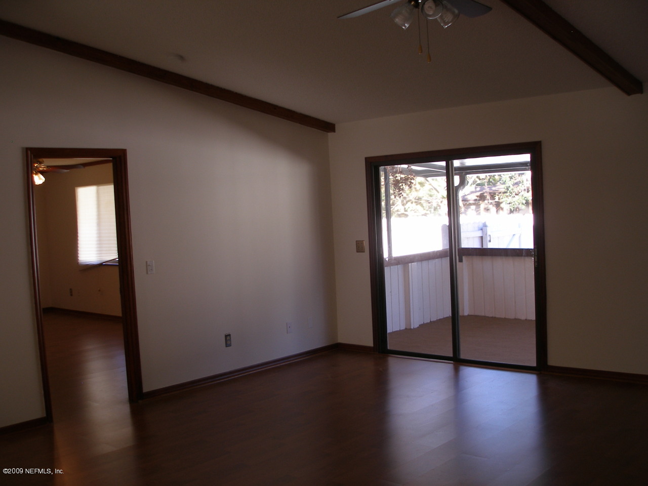 213 Gentian Road St. Augustine, FL 32086 - Photo 3 of 11 an empty room with wooden floor and windows