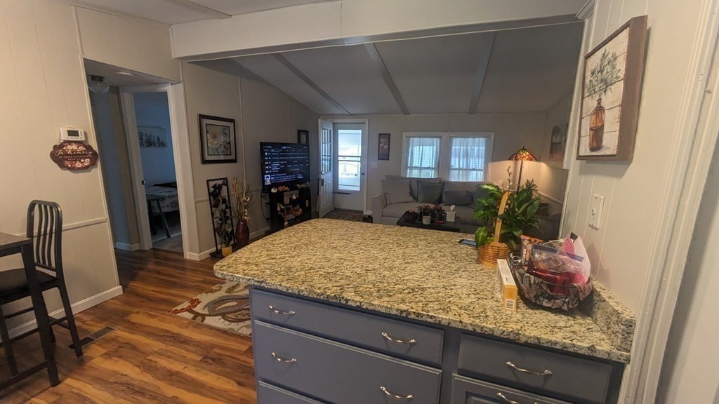 41 Victorian Way West Bridgewater, MA 02379 - Photo 3 of 16 a room with kitchen island granite countertop furniture and a wooden floor