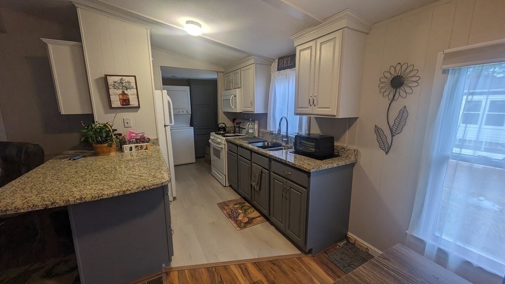 41 Victorian Way West Bridgewater, MA 02379 - Photo 4 of 16 a kitchen with stainless steel appliances granite countertop a stove a sink and a refrigerator