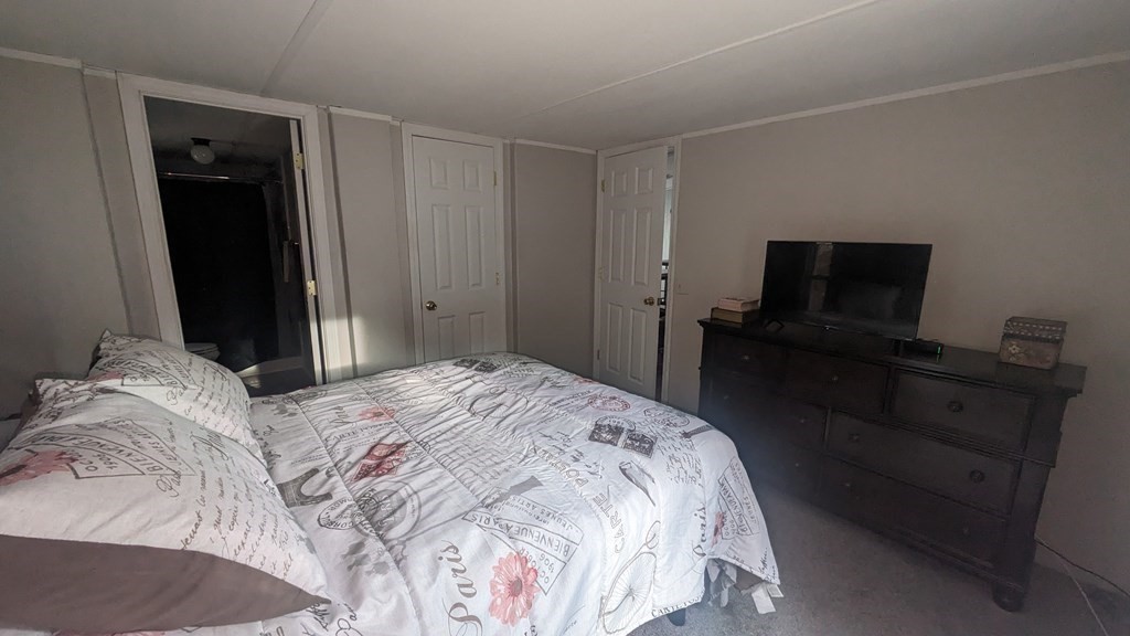 41 Victorian Way West Bridgewater, MA 02379 - Photo 8 of 16 a bedroom with a bed and a flat tv screen on a dresser