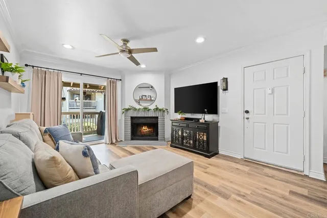 a living room with fireplace furniture and a flat screen tv