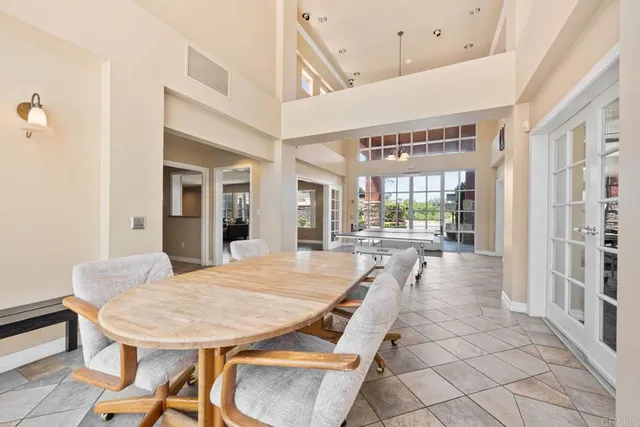 a dining room with furniture and a floor to ceiling window