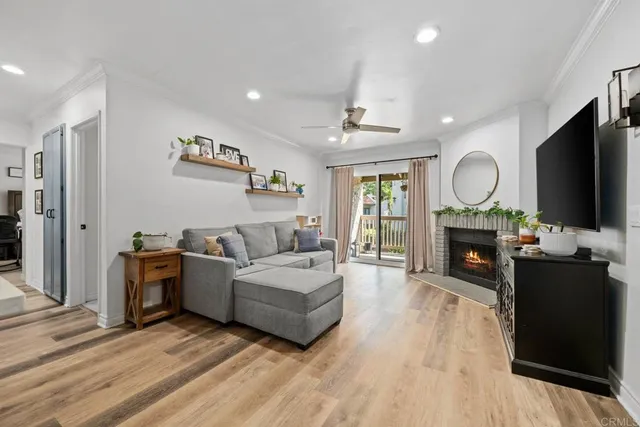 a living room with furniture a fireplace and a flat screen tv