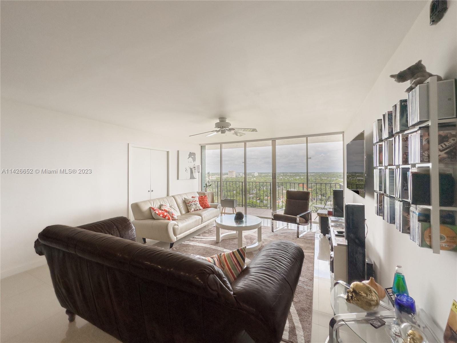 780 Northeast 69th Street, Unit 1408 Miami, FL 33138 - Photo 13 of 25 a living room with furniture and a large window