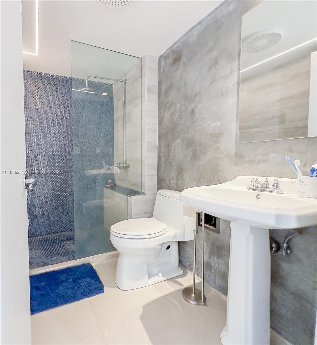 780 Northeast 69th Street, Unit 1408 Miami, FL 33138 - Photo 4 of 25 a bathroom with a sink toilet and shower