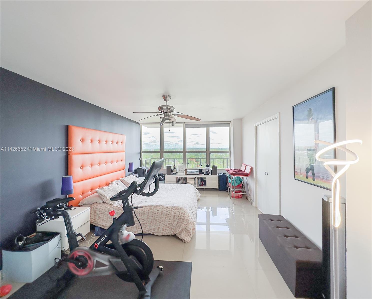 780 Northeast 69th Street, Unit 1408 Miami, FL 33138 - Photo 8 of 25 a bedroom with furniture a large window and a chandelier