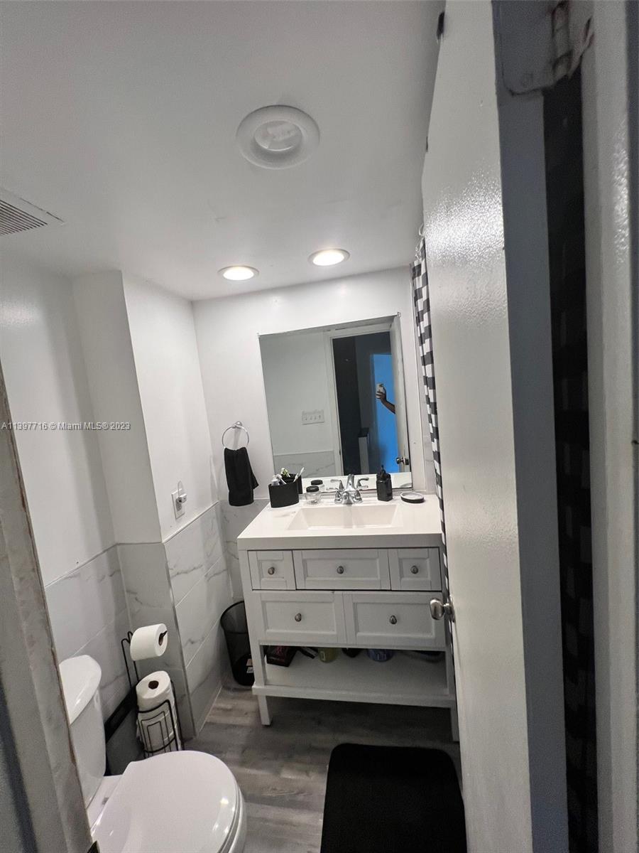 a view of bathroom with a toilet sink and mirror