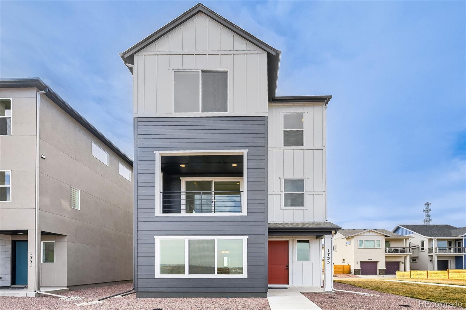 1735 Keystone Crest Lane Colorado Springs, CO 80904 - Photo 1 of 30 a front view of a house with large windows