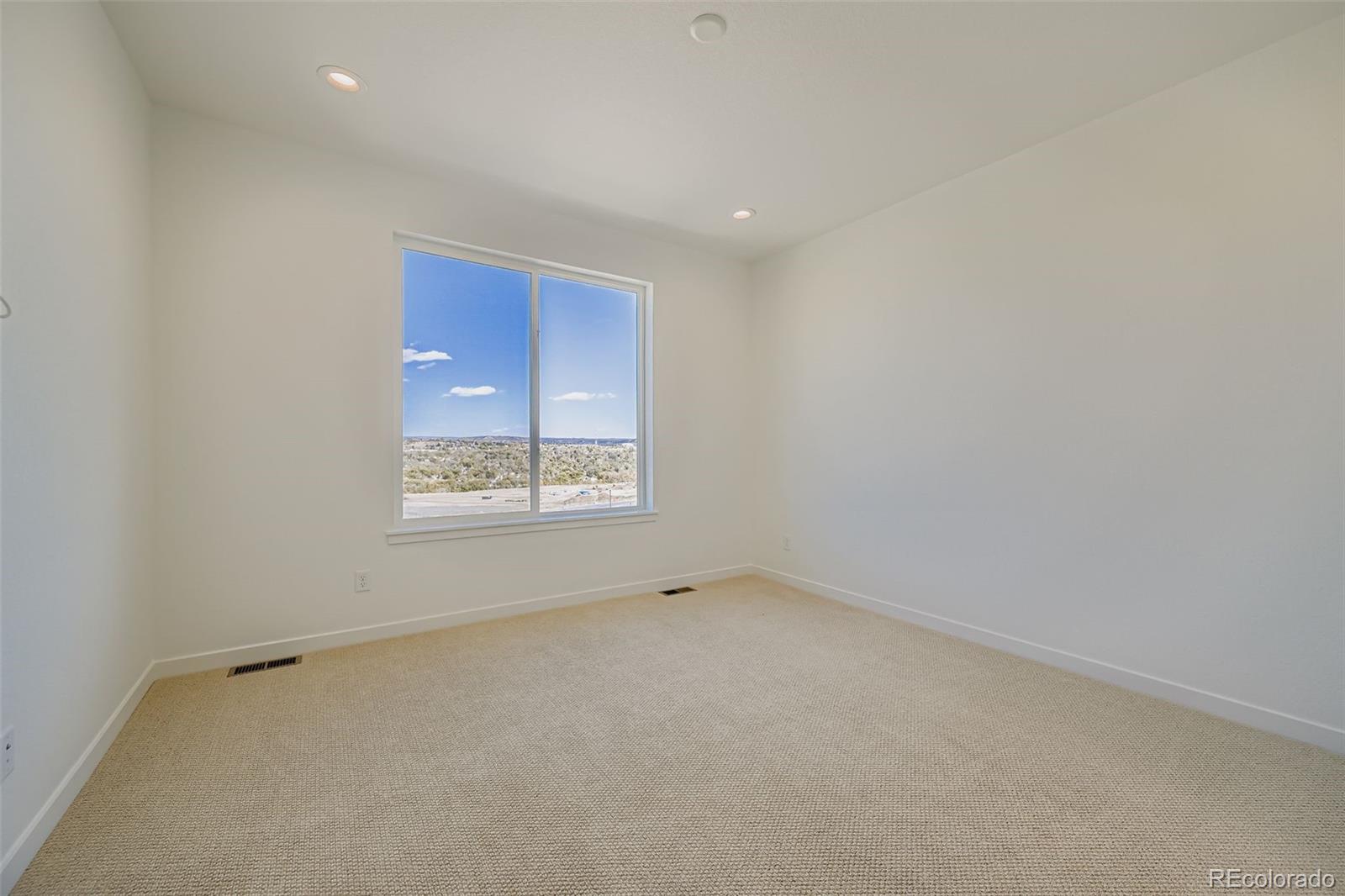 1735 Keystone Crest Lane Colorado Springs, CO 80904 - Photo 14 of 30 a view of an empty room with a window
