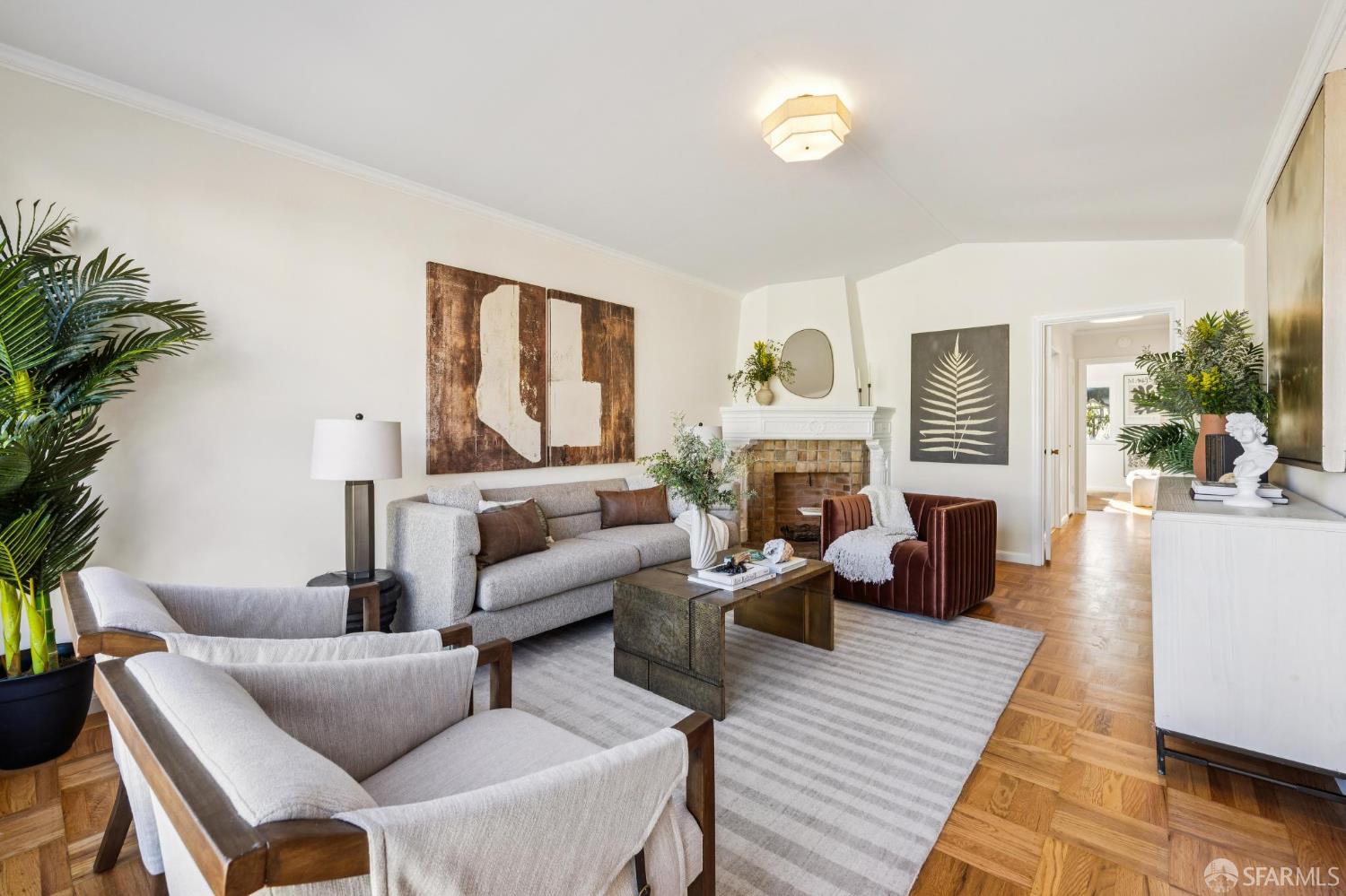 a living room with furniture fireplace and a large window