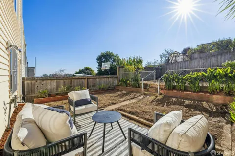 a view of a patio with couches chairs and potted plants