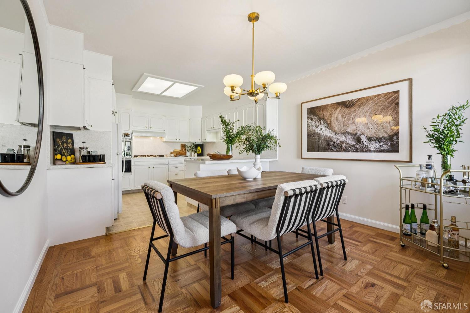 159 Stillings Avenue San Francisco, CA 94131 - Photo 4 of 21 a view of a dining room and livingroom with furniture wooden floor a rug a painting and a chandelier