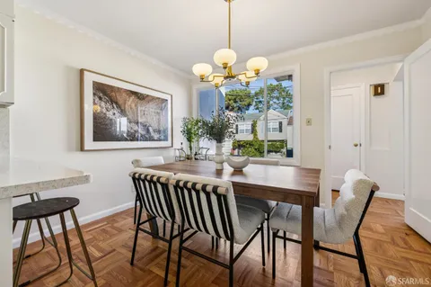 a view of a dining room with furniture and chandelier