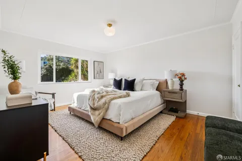 a bedroom with a bed and window